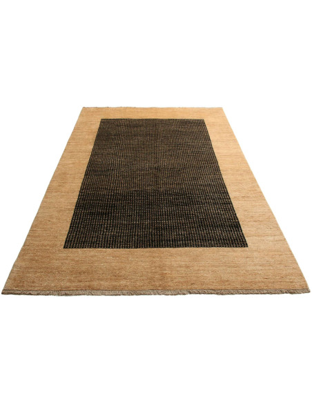 Shayan Pakistani hand-carded wool rug. Geometric black and sand design, vibrant texture. Ideal for modern and minimalist spaces.