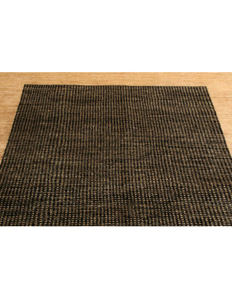 Shayan Pakistani hand-carded wool rug. Geometric black and sand design, vibrant texture. Ideal for modern and minimalist spaces.