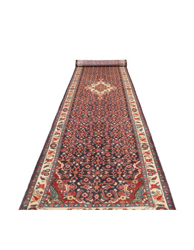 Persian Hamadan hand-knotted wool runner. Geometric and floral motifs on blue, red, and cream field. Ideal for hallways.