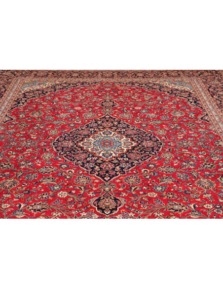 Discover the Ardakan Persian rug, a hand-carded wool masterpiece featuring a central medallion and floral design on a red field.
