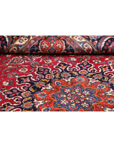 Esplora l'eleganza di questo tappeto Mashad persiano, annodato a mano in lana. Presenta un vivace campo rosso, medaglione centra