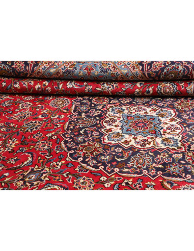 Explore the Persian Ardakan rug: hand-carded wool, floral medallion design on a red field and blue borders. Classic elegance fro