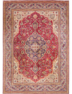 Explore the classic Persian Tabriz carpet with floral medallion, hand-carded wool. Red, blue, cream colors. Authentic elegance f