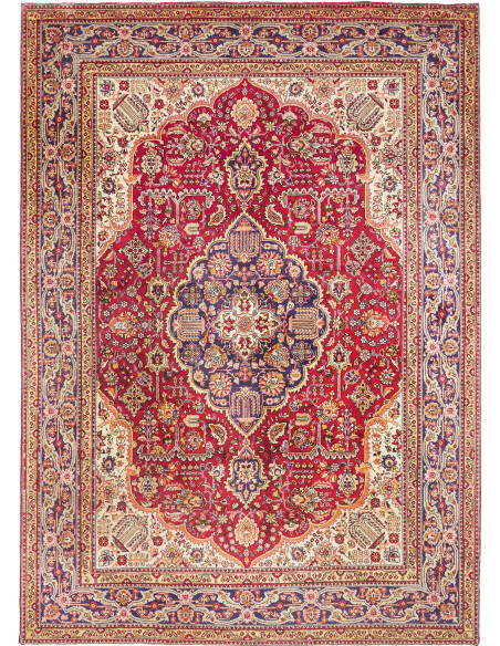 Explore the classic Persian Tabriz carpet with floral medallion, hand-carded wool. Red, blue, cream colors. Authentic elegance f