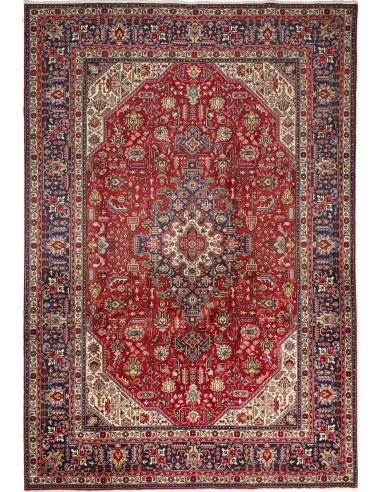 Original Persian Tabriz rug. Central medallion, red field, blue border. Hand-carded wool. Timeless elegance and tradition.