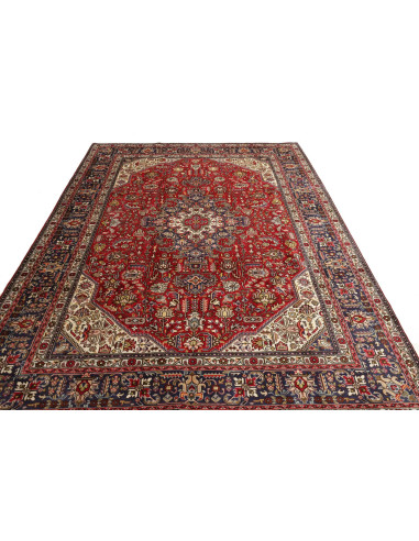 Original Persian Tabriz rug. Central medallion, red field, blue border. Hand-carded wool. Timeless elegance and tradition.