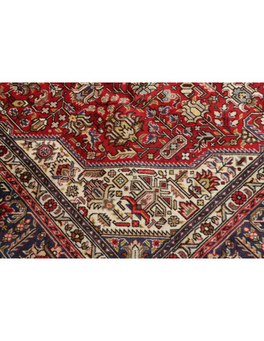 Original Persian Tabriz rug. Central medallion, red field, blue border. Hand-carded wool. Timeless elegance and tradition.