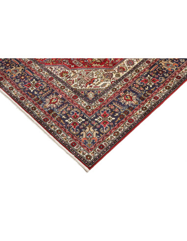 Original Persian Tabriz rug. Central medallion, red field, blue border. Hand-carded wool. Timeless elegance and tradition.