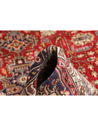 Original Persian Tabriz rug. Central medallion, red field, blue border. Hand-carded wool. Timeless elegance and tradition.