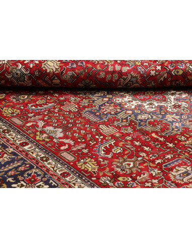 Original Persian Tabriz rug. Central medallion, red field, blue border. Hand-carded wool. Timeless elegance and tradition.