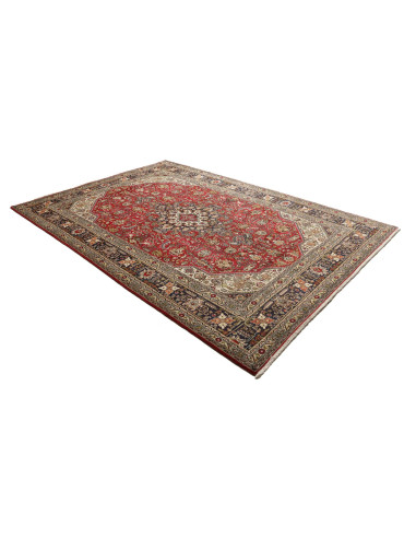 Discover the elegance of this Persian Tabriz rug. Floral medallion on a red field, blue border, and cream details. High-quality 