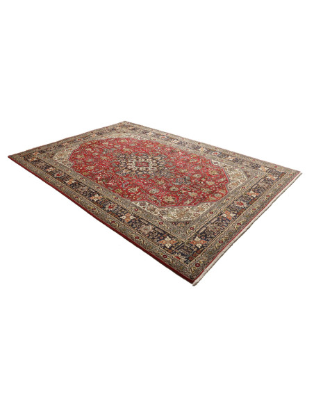 Discover the elegance of this Persian Tabriz rug. Floral medallion on a red field, blue border, and cream details. High-quality 