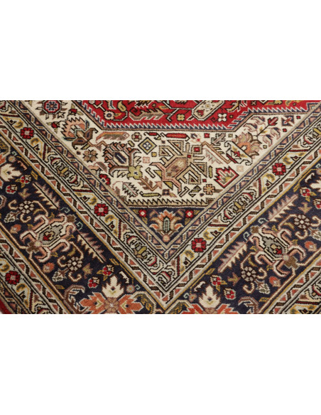 Discover the elegance of this Persian Tabriz rug. Floral medallion on a red field, blue border, and cream details. High-quality 